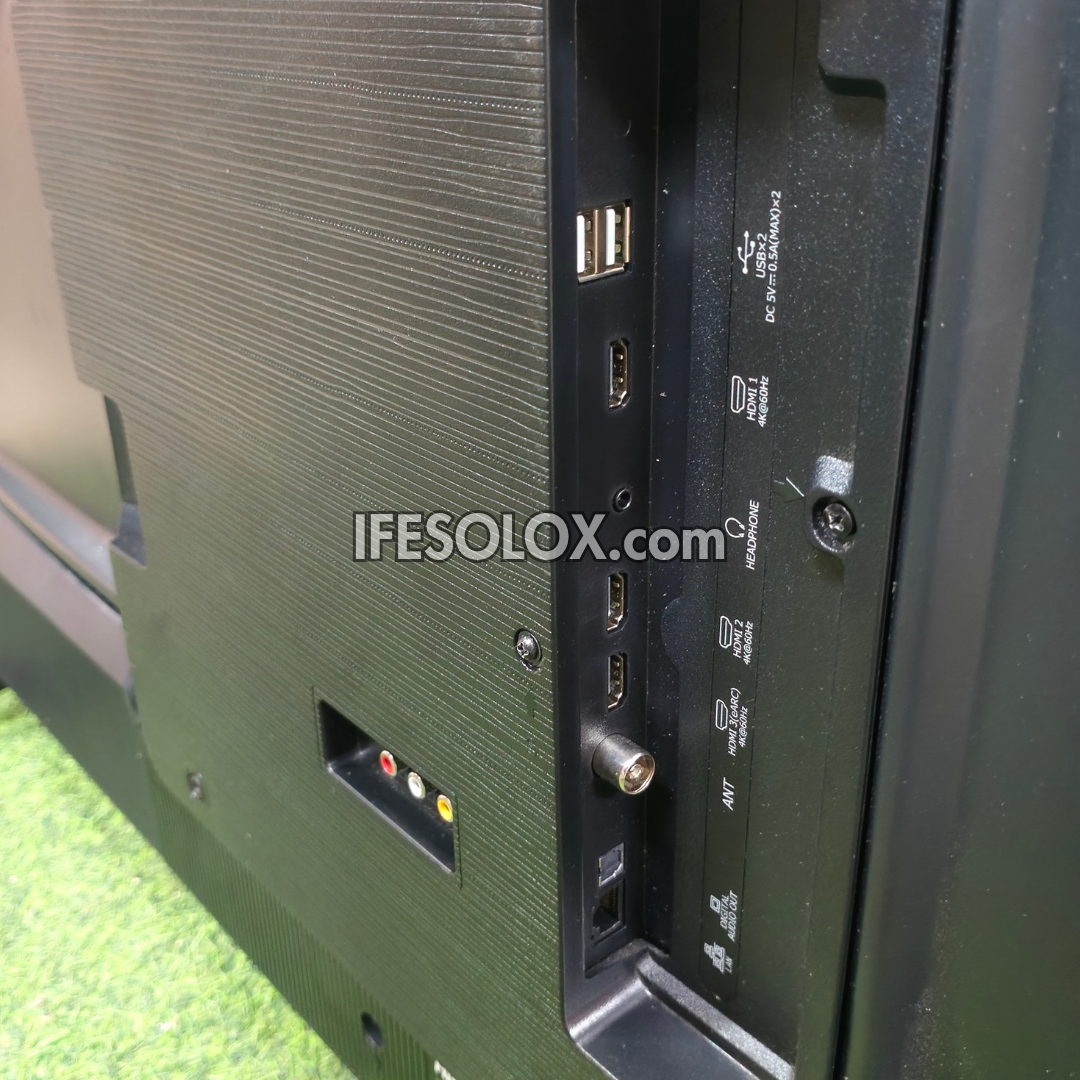 Close-up of the rear I/O panel of a Hisense QLED television, showing various ports including USB, HDMI, DisplayPort, VGA, and RF, with a watermark 'IFESOLOX.com' across the center.