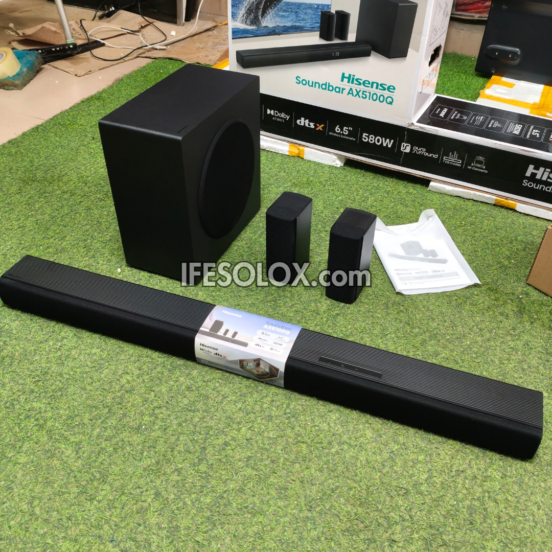 Hisense Soundbar AX5100Q 5.1 surround sound system with a long black bar, a black subwoofer, two small satellite speakers, and retail packaging 