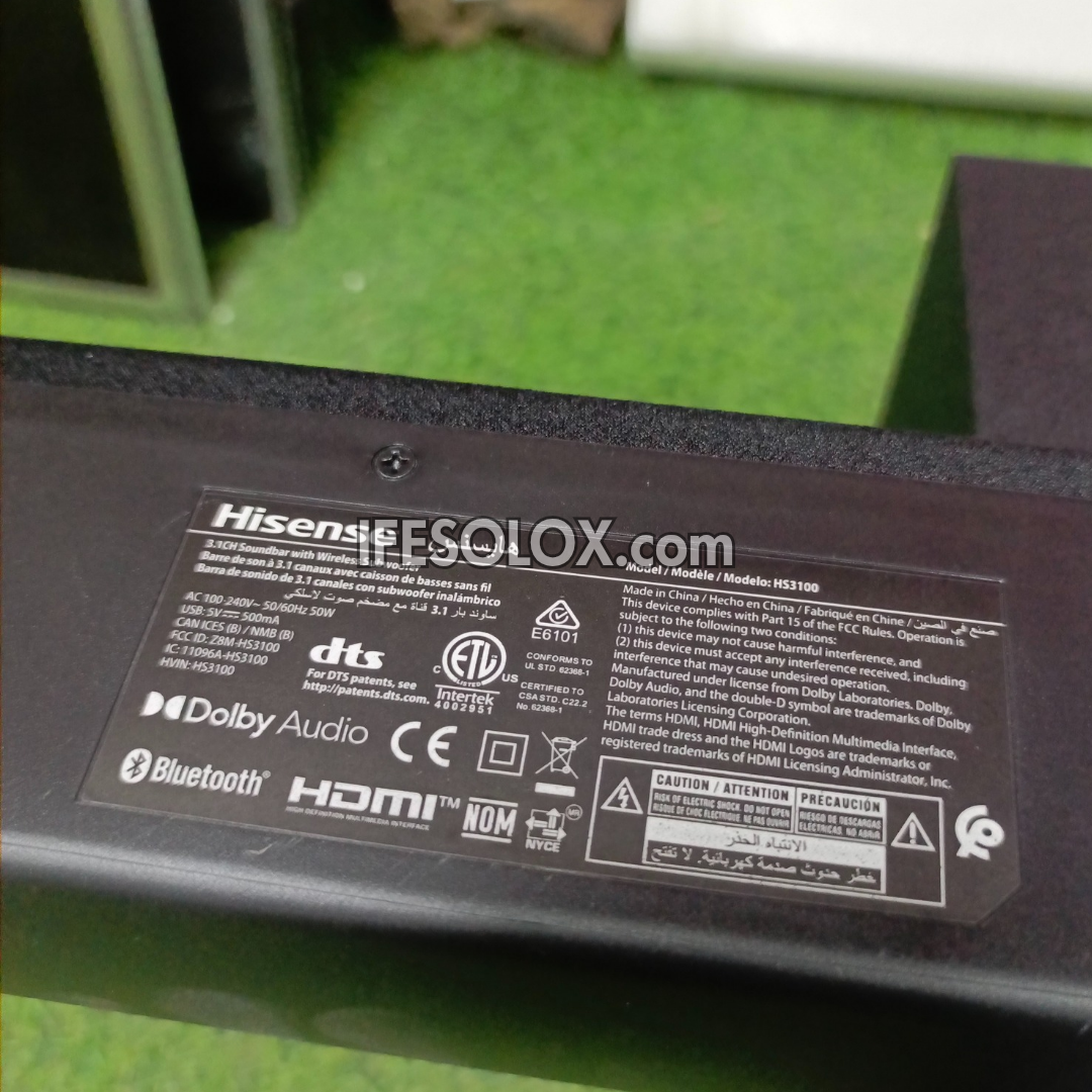 Back of a Hisense sound bar with branding and certification logos on a green surface.