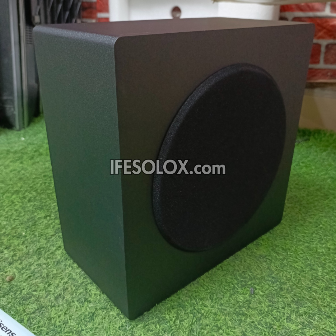 Black speaker subwoofer on a green surface with 'IFESOLOX.com' branding.