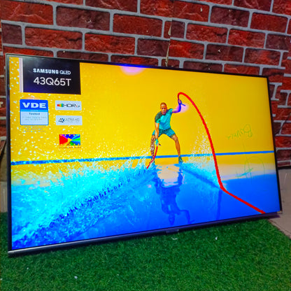 Samsung TV displaying a sports scene with a person on a surfboard against a brick wall.