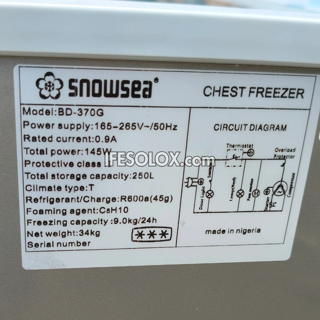 A close-up of a Snowsea chest freezer label showing product details, model BD-370G, power supply, capacity, and a circuit diagram on a white sticker applied to a gray appliance.