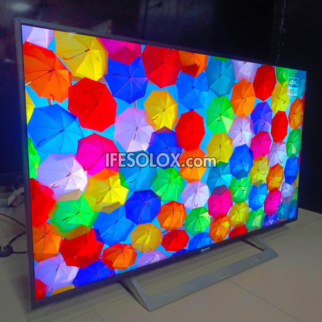 Sony Android TV screen displaying colorful umbrella pattern with 'IFESOLOX.com' branding.