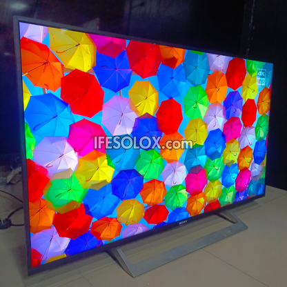 Sony Android TV screen displaying colorful umbrella pattern with 'IFESOLOX.com' branding.